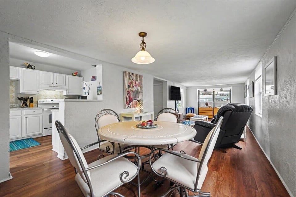 Dining area with round glass table and seating for four