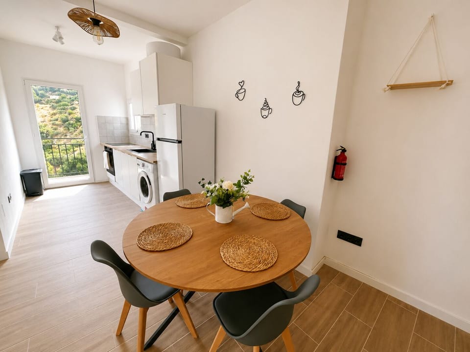 Bright modern kitchen-diner with hillside views and seating for four