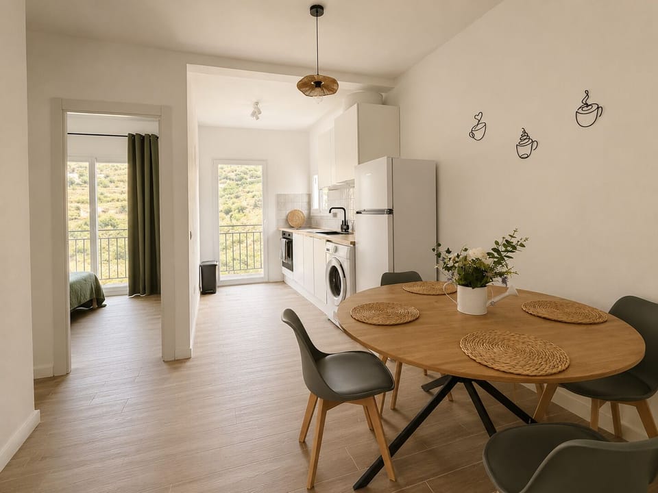 Bright open-plan dining area with balcony views and modern kitchen