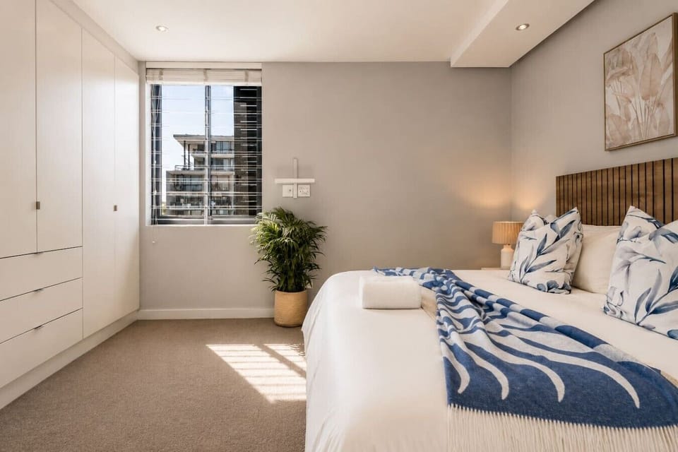 Bedroom 1: Airy king bedroom with built-in wardrobes, natural light & city views