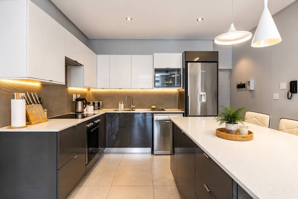 Kitchen & Dining: Sleek, modern kitchen with generous counter space, stylish lighting, and a clean contemporary finish.