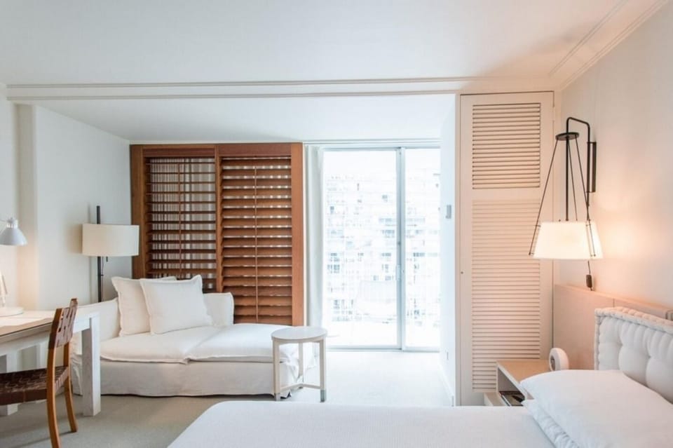 King Bed • Tufted Headboard, White Linens & Balcony Access