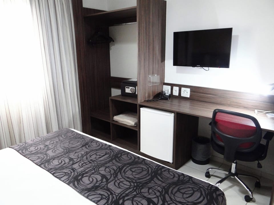 Settle in and get productive with desk, TV, and storage.
