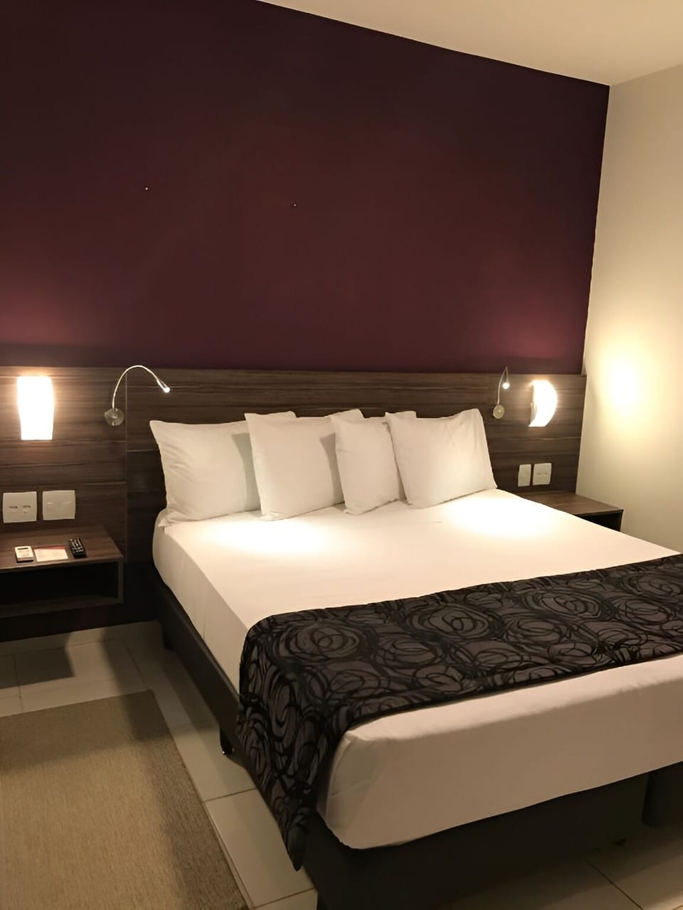 Unwind in a sleek, restful room with plush pillows.