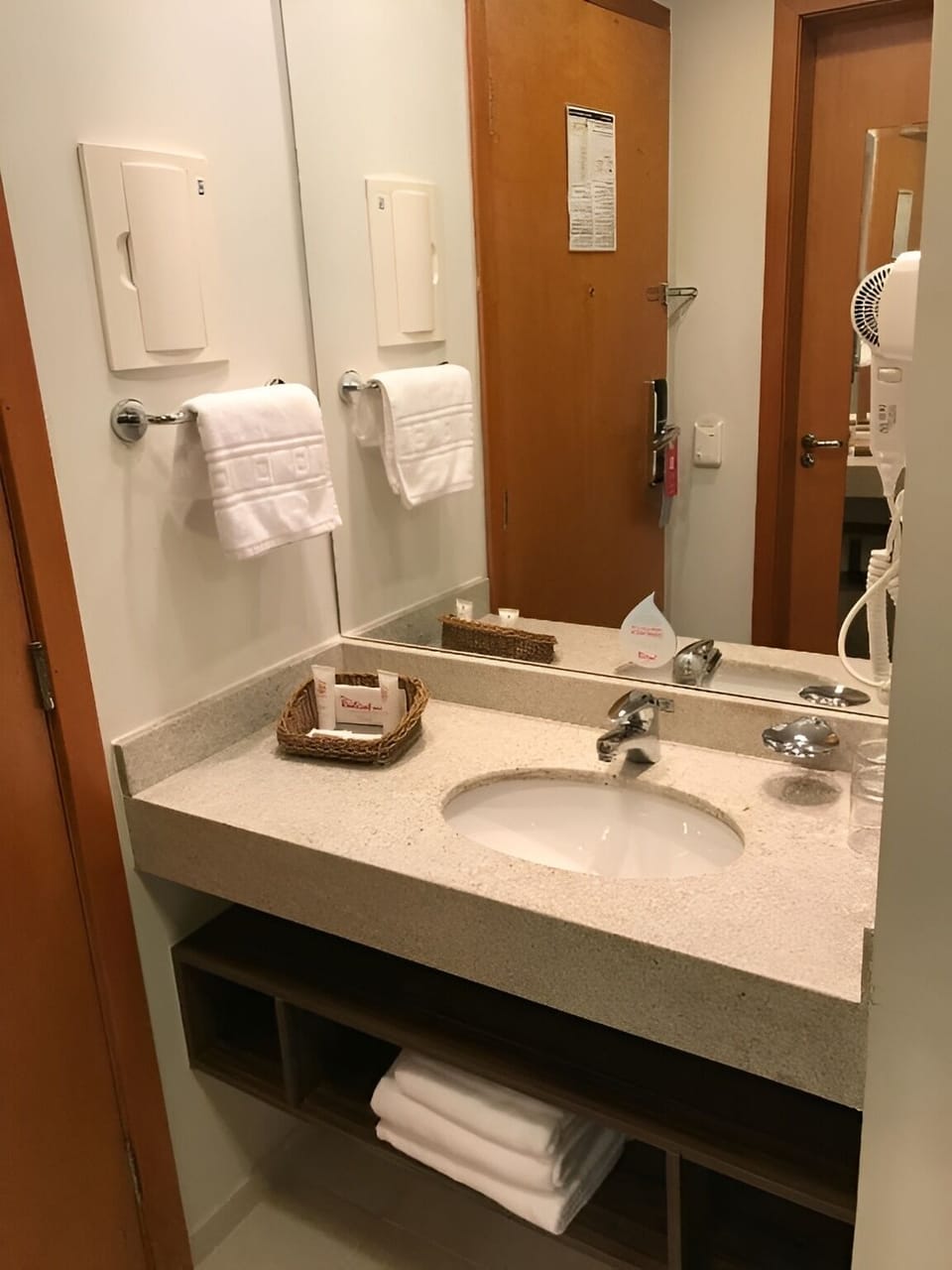Refresh at a bright vanity with towels and essentials ready.