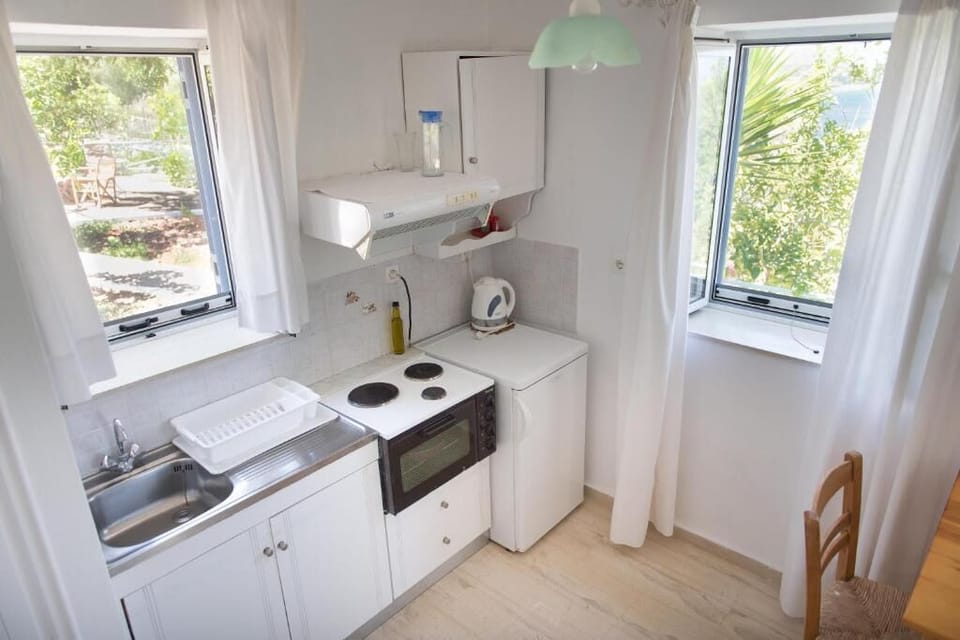 Bright, fully equipped kitchen with beautiful views of the surrounding greenery.