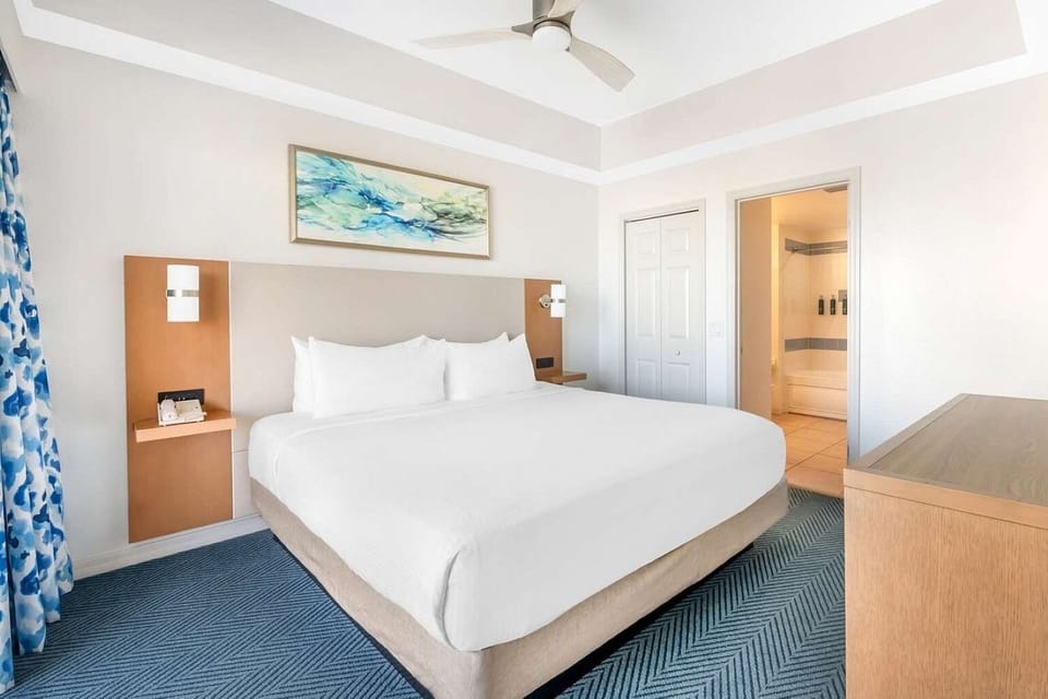Primary Bedroom • King Bed, Wall Sconces & En-Suite Access
