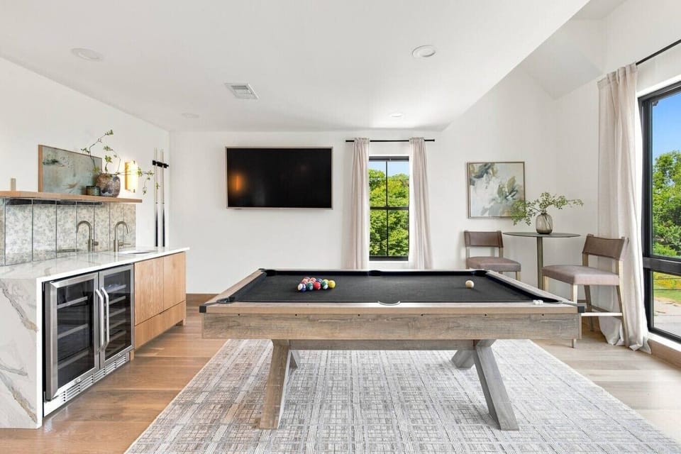 Spend time in the game room, complete with a pool table, wet bar, high-top seating, and a TV—perfect for catching the game, enjoying a drink, or challenging friends and family to a round of pool.