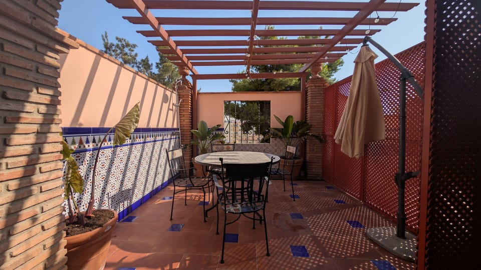Private terrace with an outdoor dining area and pergola, perfect for enjoying the Malaga sunshine.