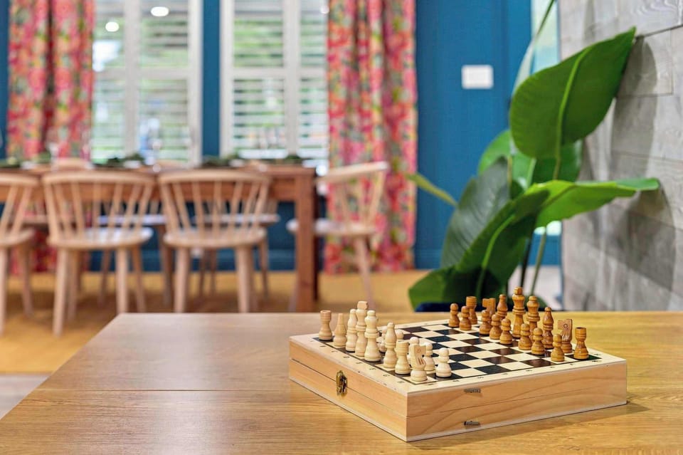 A chess board set and ready on the table — rainy afternoons and quiet evenings come with their own built-in entertainment here.