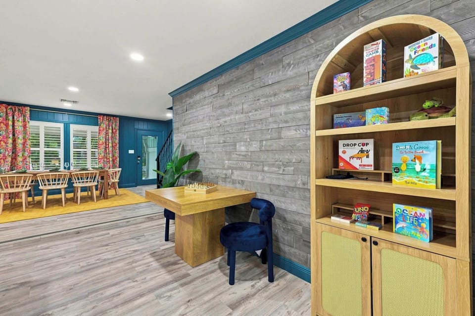 A quiet little reading corner stocked with books gives the youngest guests a spot to slow down between pool sessions.