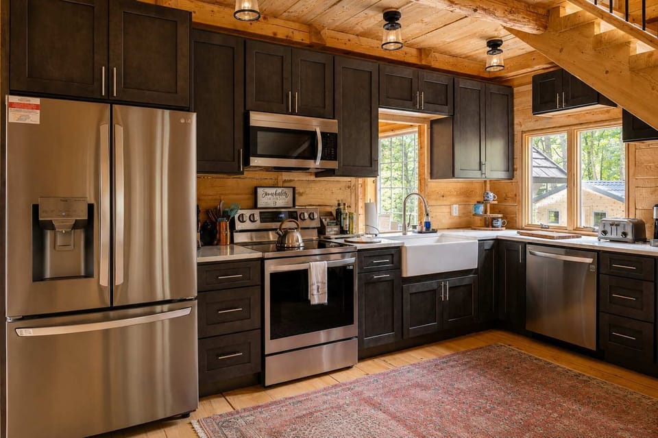 Cook up memories in a chef ready kitchen with stainless appliances, dual ovens and a farmhouse sink, all wrapped in warm log cabin charm.
