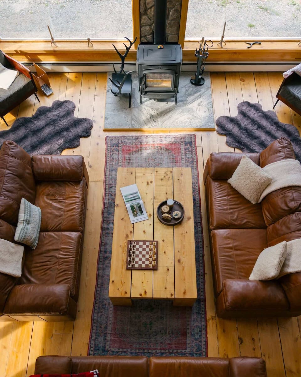 Sink into leather sofas facing each other, with a checkers table waiting for a rematch and stacked wood ready for a chilly evening.