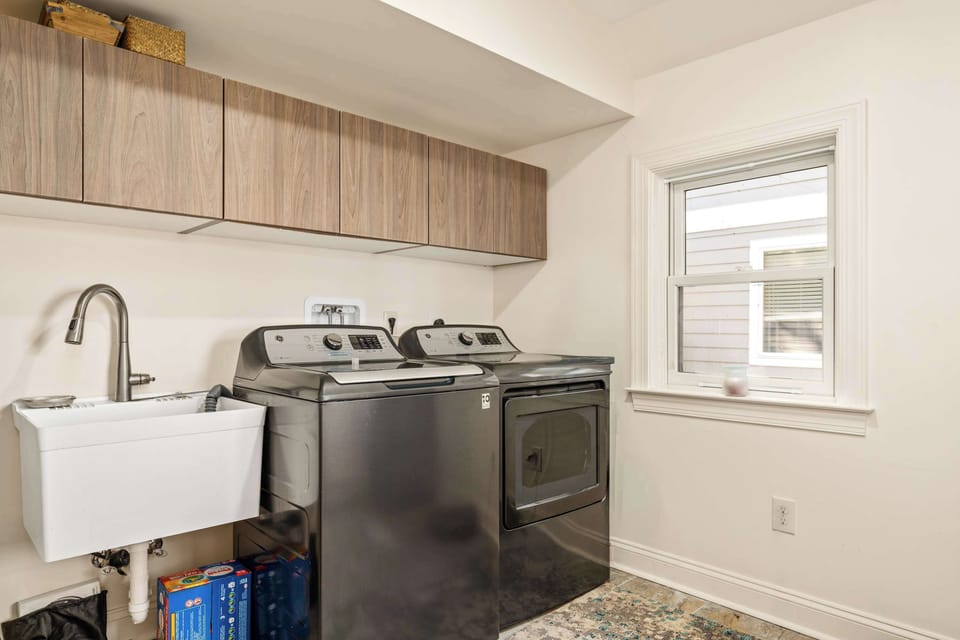 Laundry room with full-size washer, dryer and utility sink