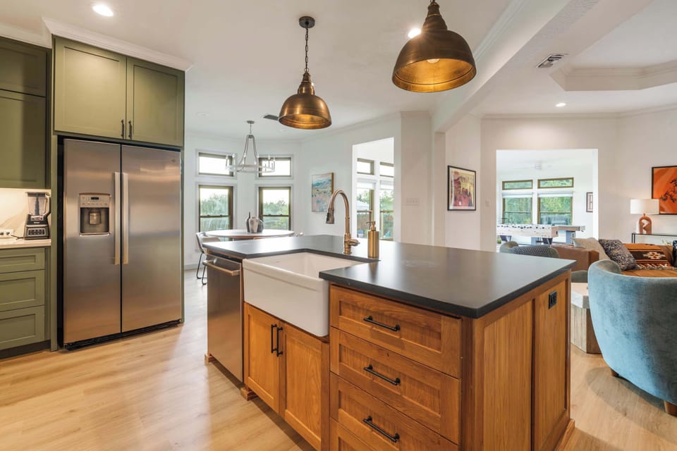 Farmhouse sink, stainless appliances, and an oversized island — this kitchen is ready for a crowd.