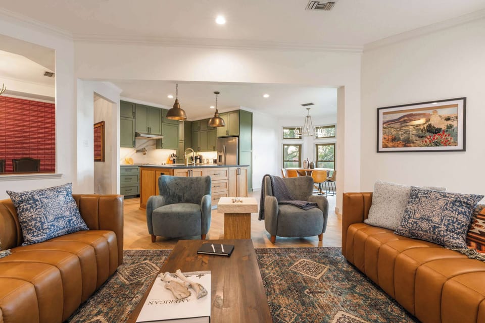 Gather around the leather sofas or head to the kitchen — this open layout keeps the whole group close.