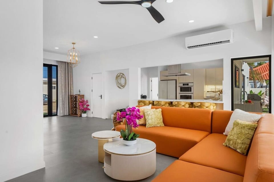 Relax and unwind in a bright, stylish living space featuring vibrant seating and beautiful views that make every moment feel special
