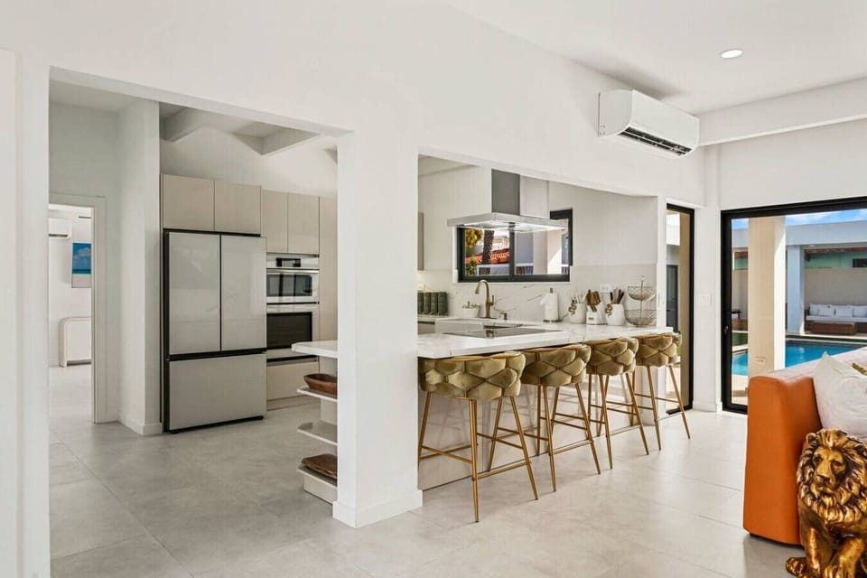 Cook, connect, and entertain in a stylish kitchen featuring sleek finishes and a spacious bar-style island with seating for four