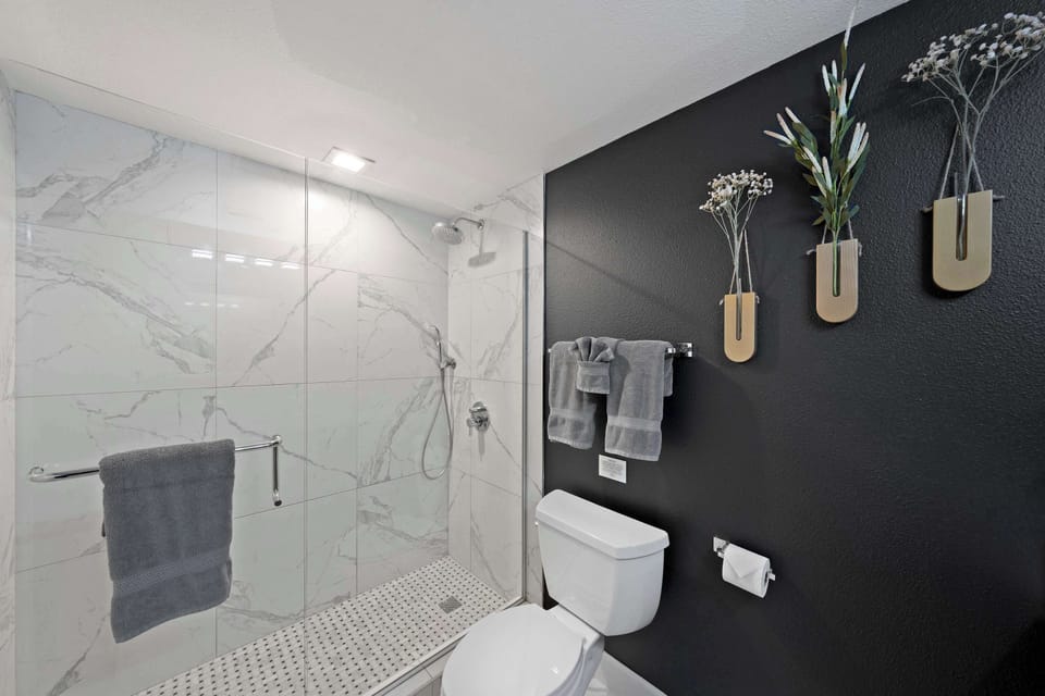 🚿 Marble-look walk-in shower with sleek glass enclosure—a clean, spa-inspired way to reset at the end of the day.