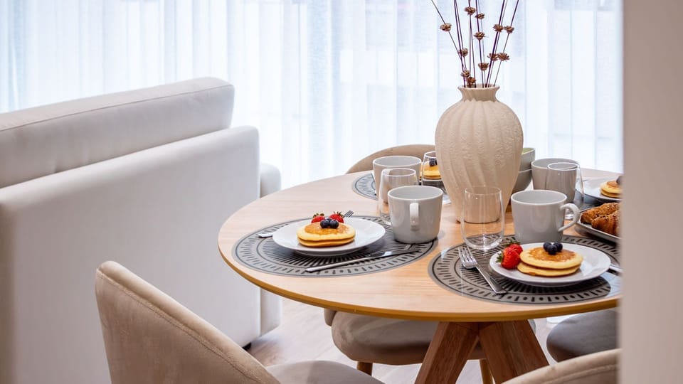 Enjoy the sophisticated ambiance of the open-plan living and dining area, where stylish abstract art complements the comfortable seating, creating an inviting space for relaxation and memorable meals. This thoughtfully designed room is ideal for unwinding