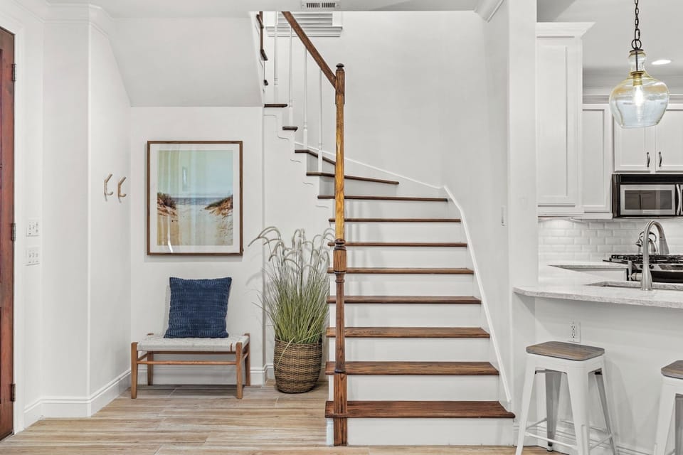 Staircase leading up to two additional bedrooms and two bathrooms 