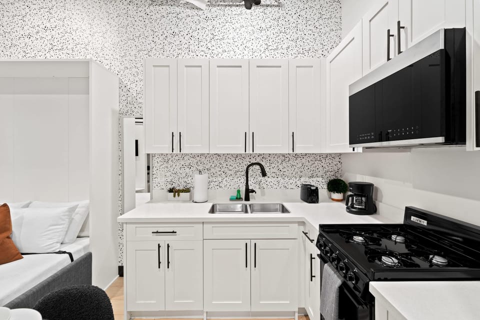 🖤 Bold black cabinetry and modern appliances—a kitchen that's as functional as it is stylish.
