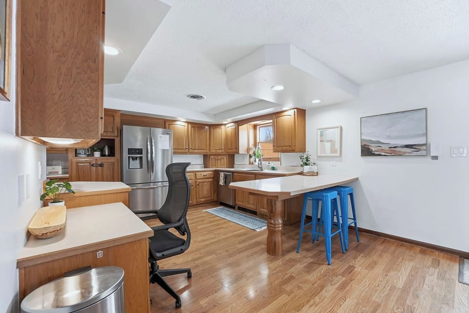 Pull up a blue barstool at the breakfast counter to chat with the chef while dinner simmers in this spacious Fort Wayne kitchen layout.