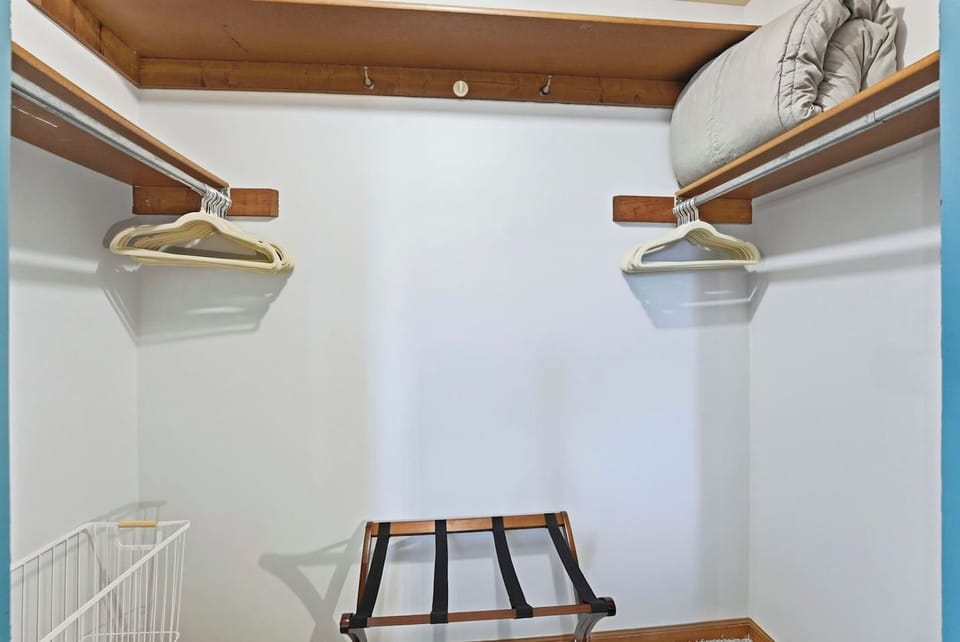 Unpack and settle into this spacious closet with sturdy wooden hangers and a luggage rack to keep your vacation outfits wrinkle-free.