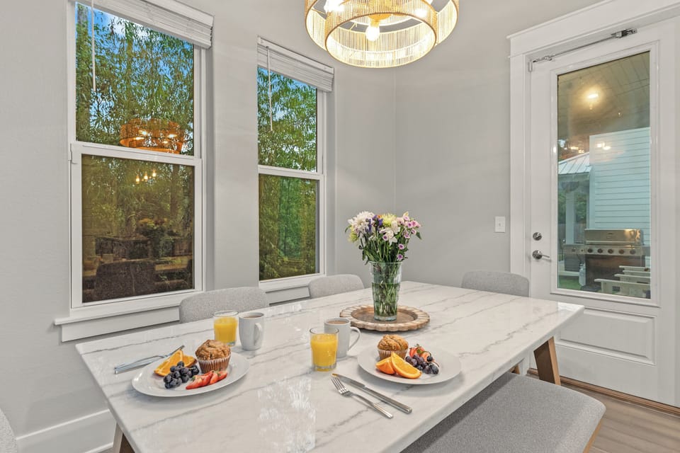 Community poolside setting with lounge chairs, umbrellas, and landscaped surroundings.