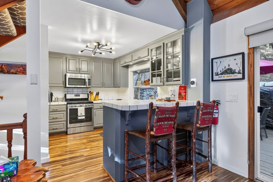 Fully equipped kitchen with breakfast-bar seating.