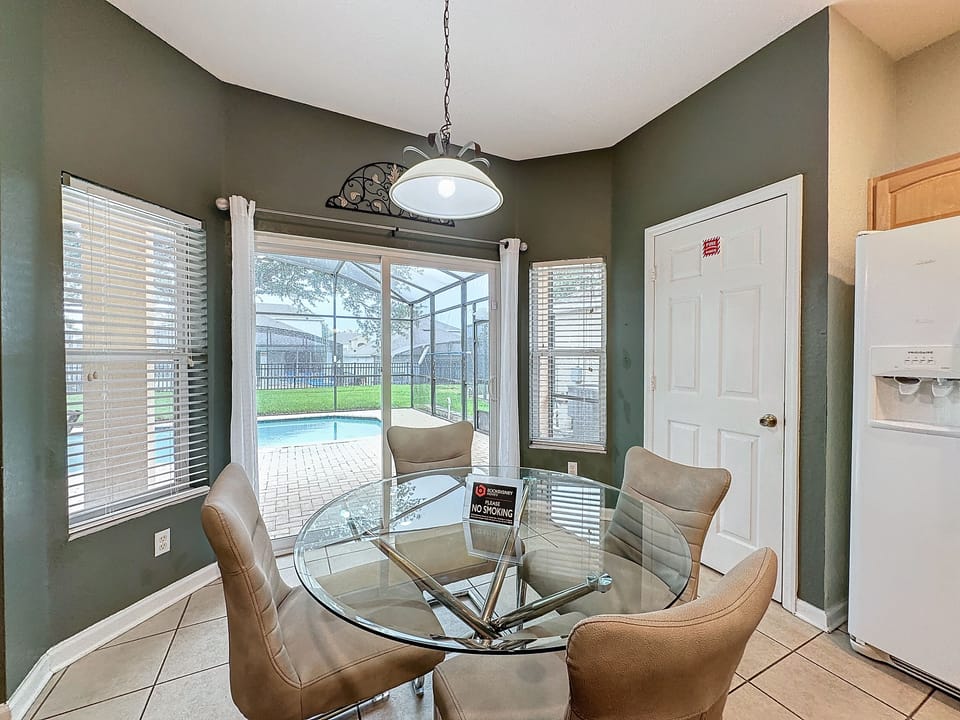 Beautiful dining area that seats four with a view of the pool.