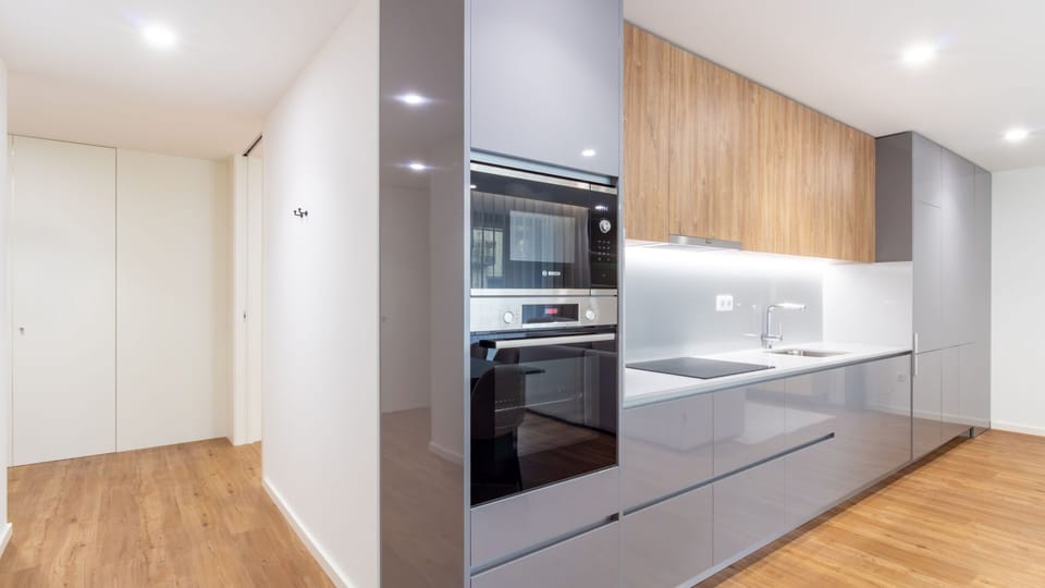 Indulge in a spa-like experience in this elegant bathroom, featuring a spacious walk-in shower with luxurious marble-effect tiling and a modern illuminated mirror. The vanity offers plenty of space for your toiletries, ensuring a refreshing start or end t