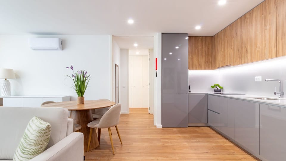 Appreciate the subtle details and stylish decor that make this living space truly inviting, from the contemporary nested coffee tables to the lush green plants. It's the perfect spot to enjoy a morning coffee or an evening read.