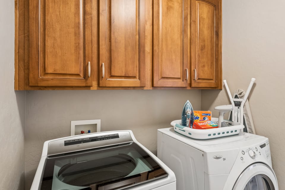 Washer, dryer, steamer, iron, and ironing board.