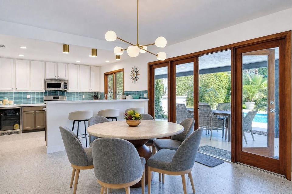 Gather around this inviting dining space where natural light streams through and your private patio awaits, perfect for morning coffee or sunset meals together.