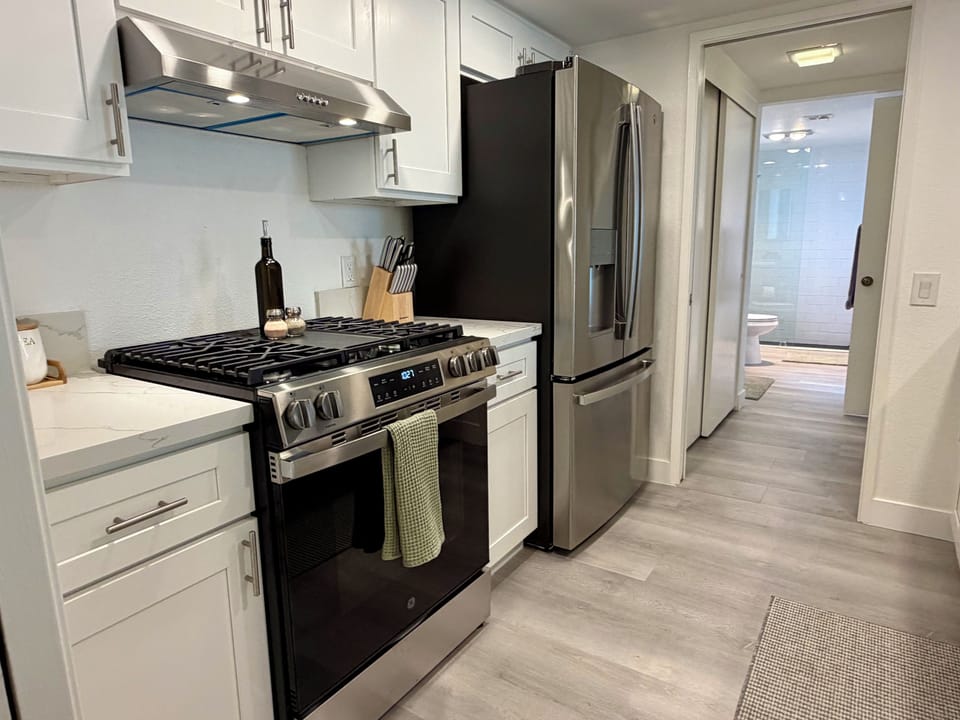 Updated kitchen with stainless steel appliances and gas range