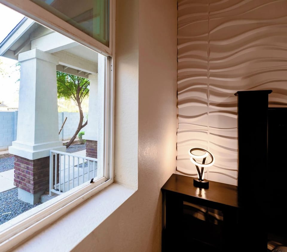 Bright window nook with modern accent wall and entry view