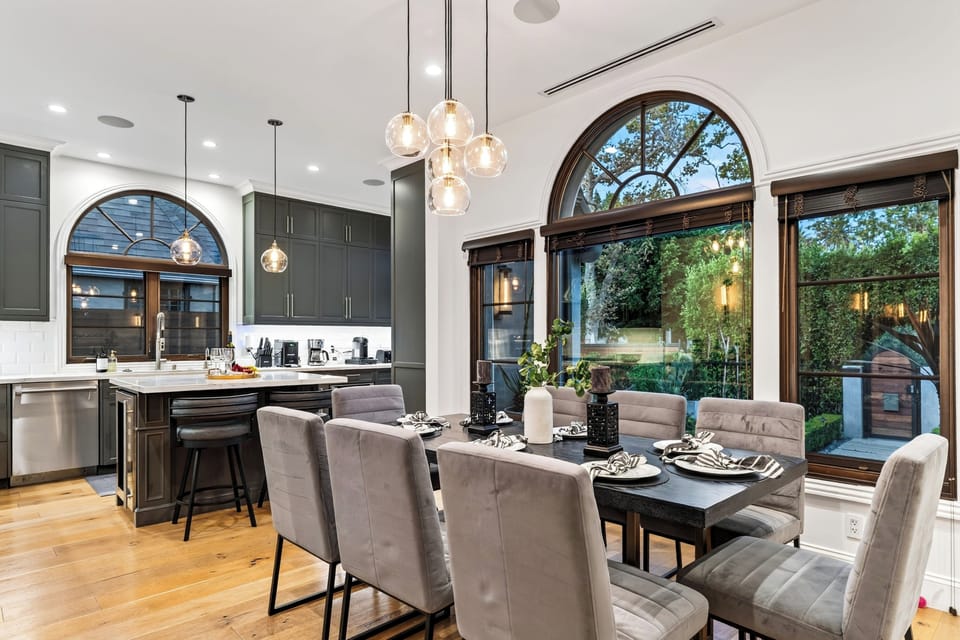 Dining space accented by large arched glass doors providing rich natural light.