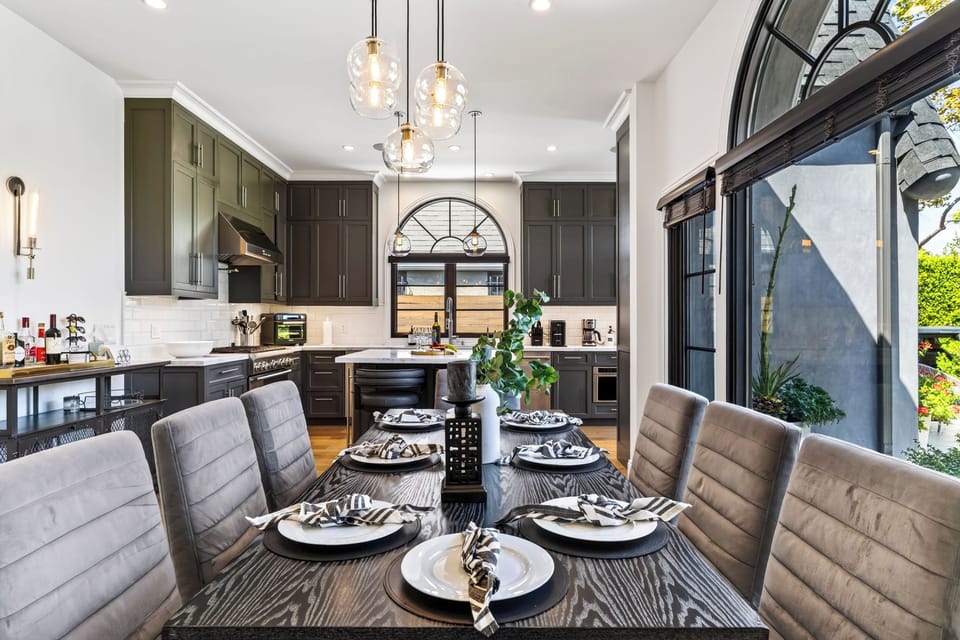 Elegant dining table setting with contemporary overhead lighting.