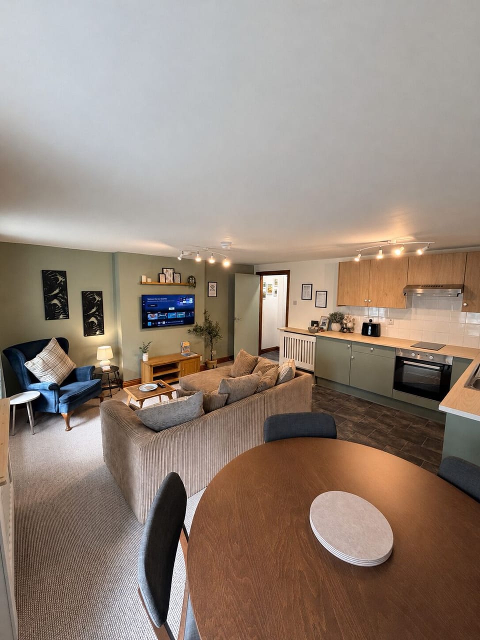 Cozy open-plan lounge, dining area, and modern kitchen space