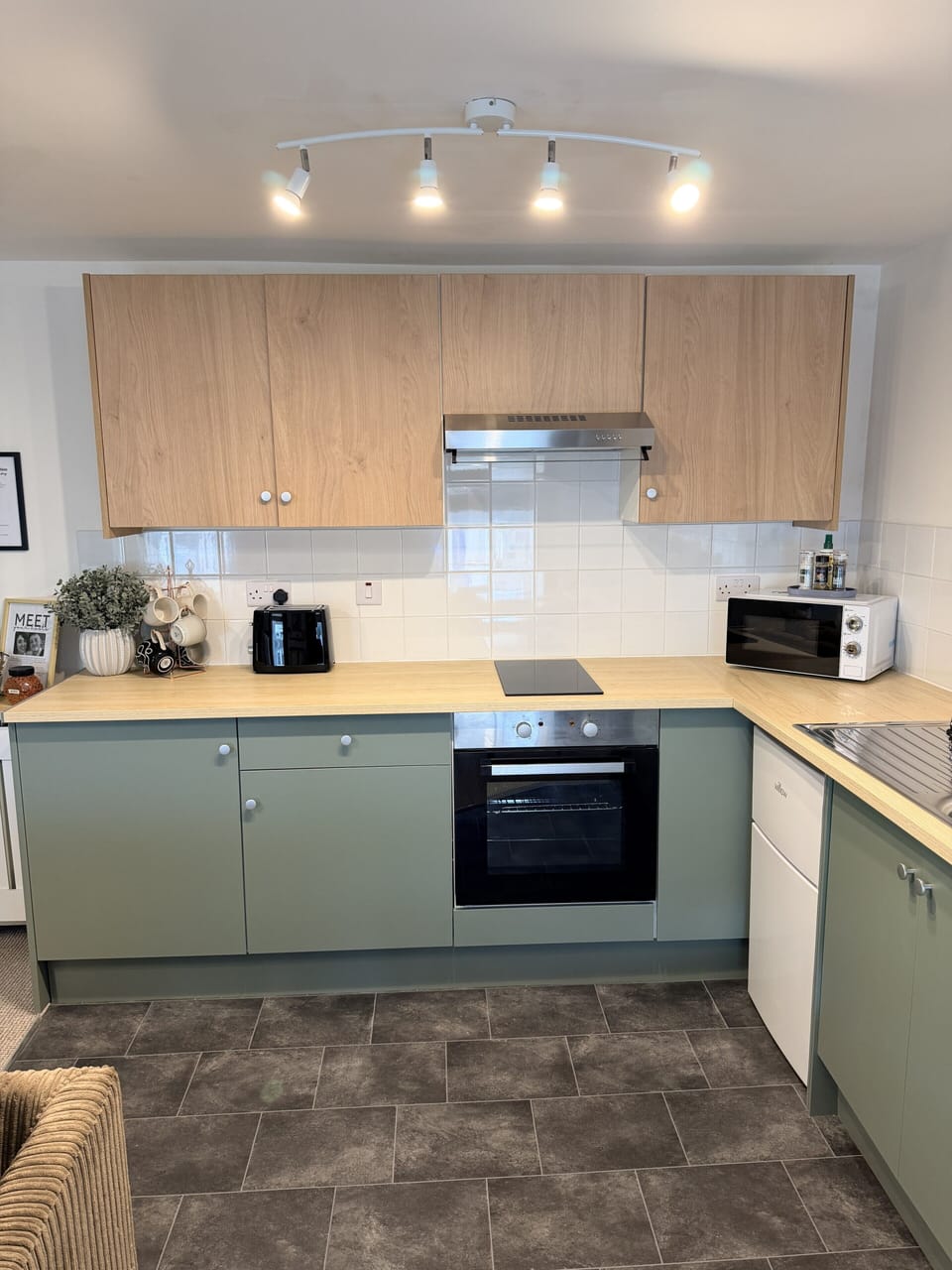 Modern fully equipped kitchen with stylish finishes and coffee station