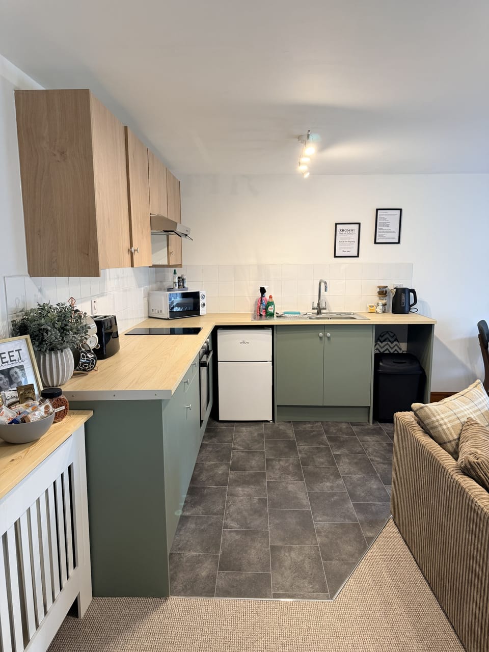 Cozy studio kitchenette with modern finishes and comfy lounge space