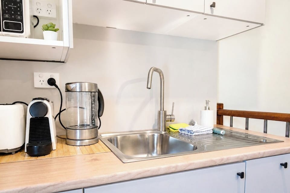 Rest comfortably in a spacious loft bedroom featuring a plush double bed, bedside lighting, and a cozy seating area