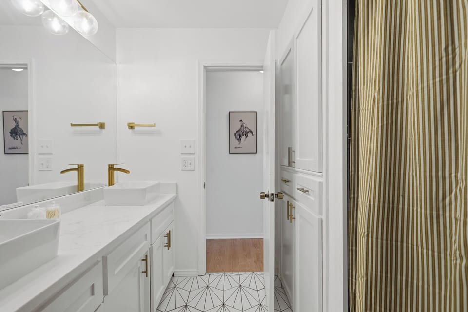2nd floor bathroom with tub, shower and dual vanities