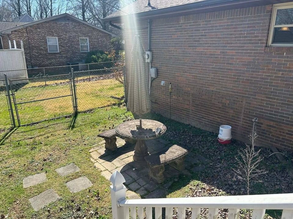 back porch sitting area fenced in backyard