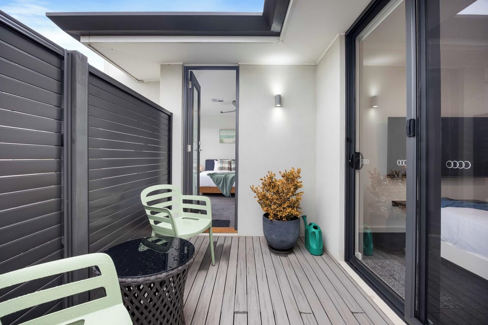 The private balcony is accessible from both the primary and second bedrooms.