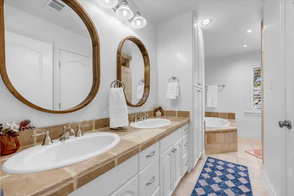 Upstairs primary bathroom with tub and shower
