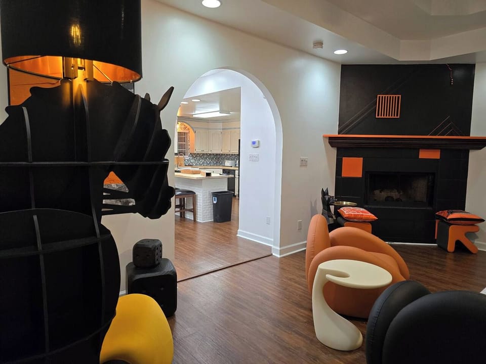 The large living room is well adorned with unique furniture sourced from around the globe. Every item has been carefully chosen for their quality, comfort, and design characteristics. 