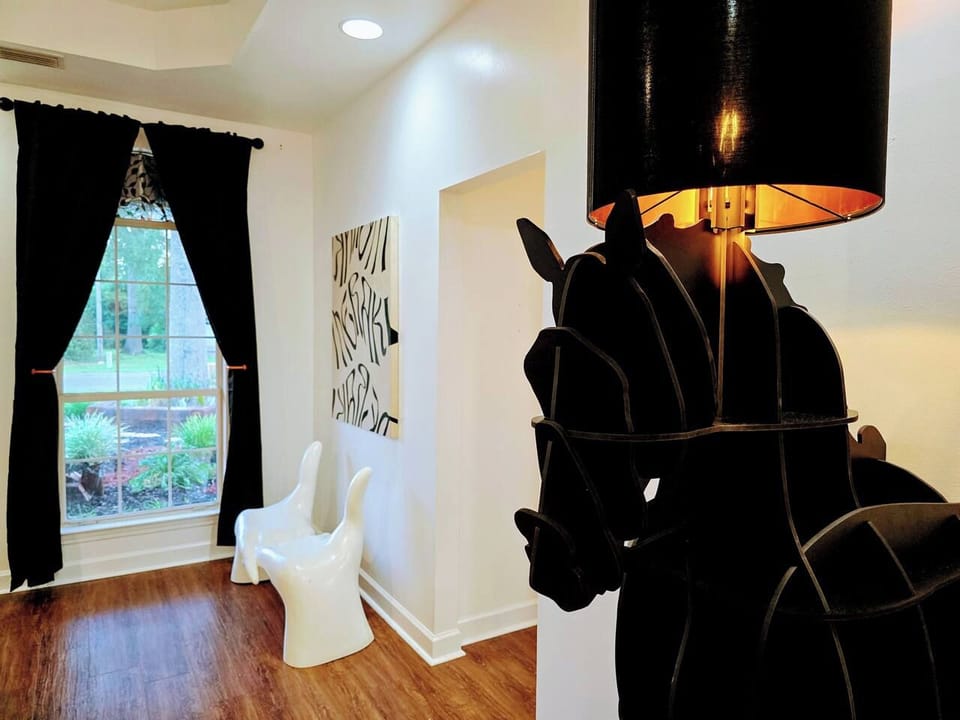 The large living room is well adorned with unique furniture sourced from around the globe. Every item has been carefully chosen for their quality, comfort, and design characteristics. 