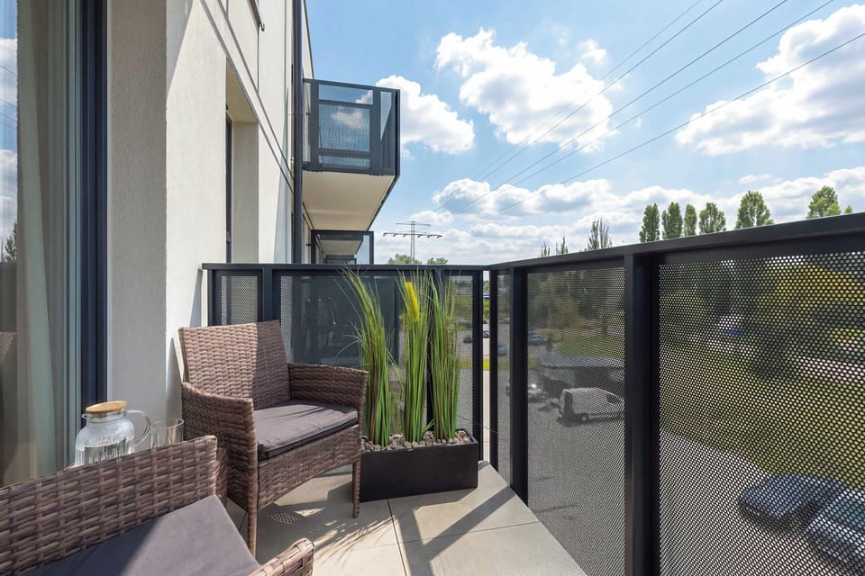 A balcony with comfortable seating and views of the surrounding area.
